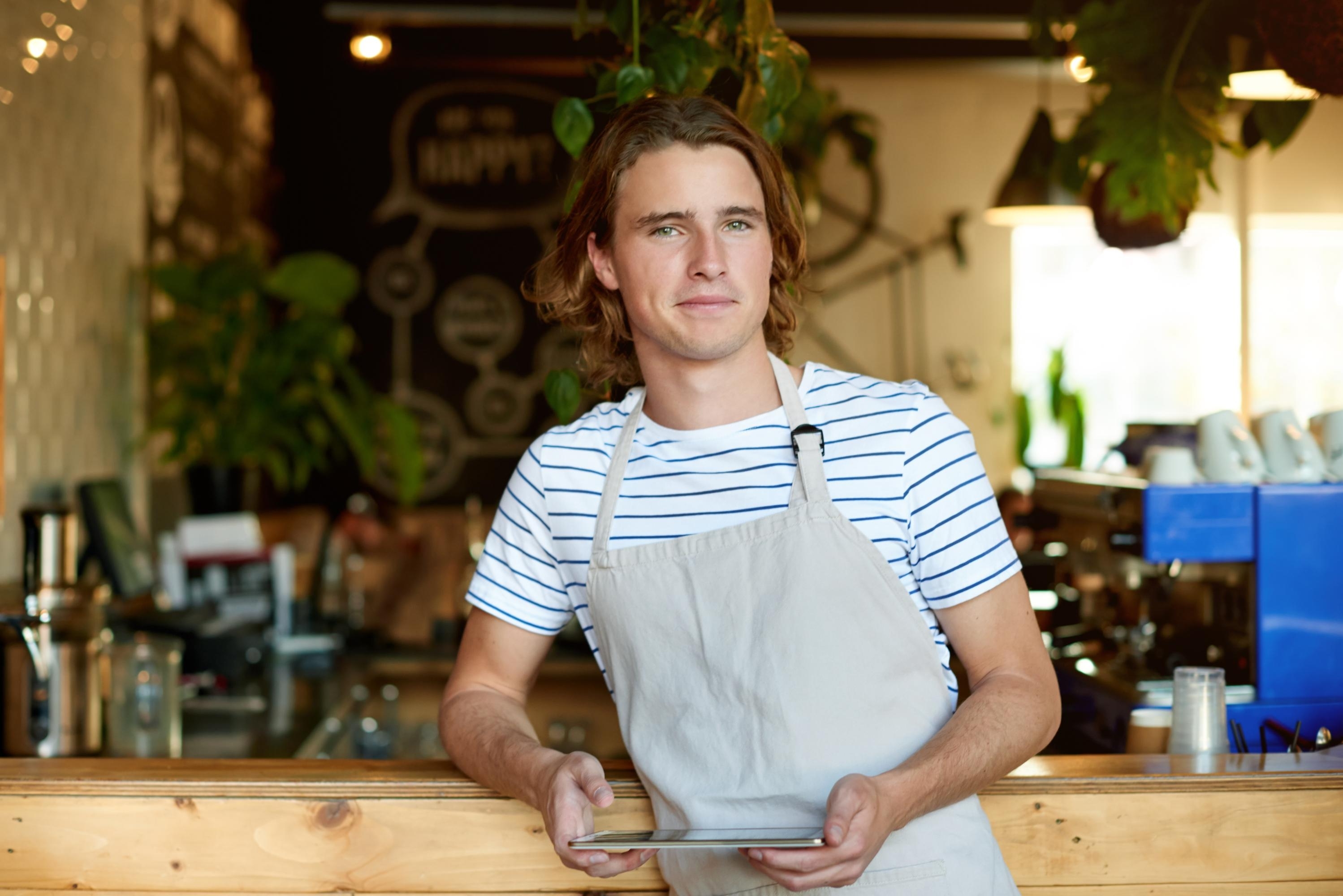 Young man working in a coffee shop